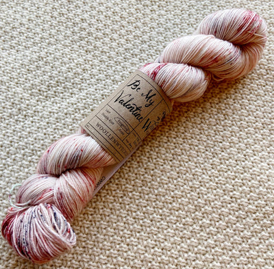 white red black fingering weight yarn in a 100g skein