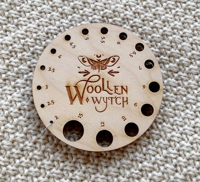 wooden circle with needle gauges in it from 2mm to 15mm