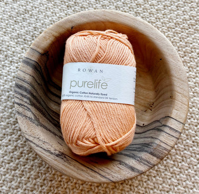 a ball of orange cotton yarn 50g ball