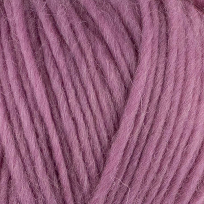 a close up of british bluefaced kerry hill fleece in light pink chunky weight yarn for knitting weaving or crochet