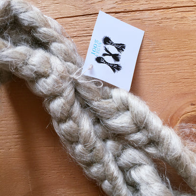 two braids of vegan linen fibre on a wooden table