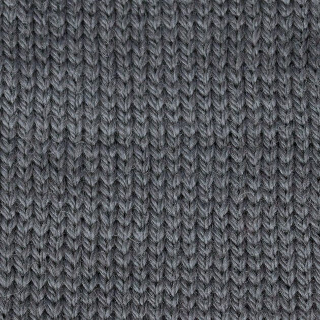 close up of knitted grey aran weight skein machine washable for knitting crocheting and weaving