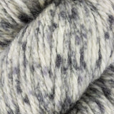 close up of white black grey  aran weight skein machine washable for knitting crocheting and weaving