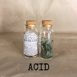 clear small cork bottle with green stitch markers in 