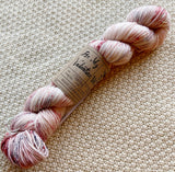 white red black fingering weight yarn in a 100g skein