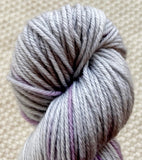 a close up of lilac purple dk double knit yarn in a 100g skein