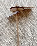 a wooden drop spindle led down