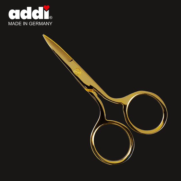 tiny metal scissors with a gold finish