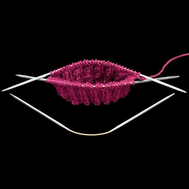 crasytrio needles with the ribbing of a pink sock 