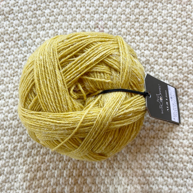 yellow alb lino 100g sock yarn wool and linen on a crocheted white blanket