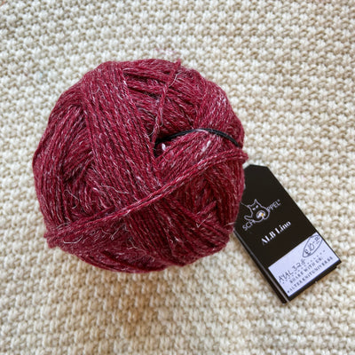 red alb lino 100g sock yarn wool and linen on a crocheted white blanket