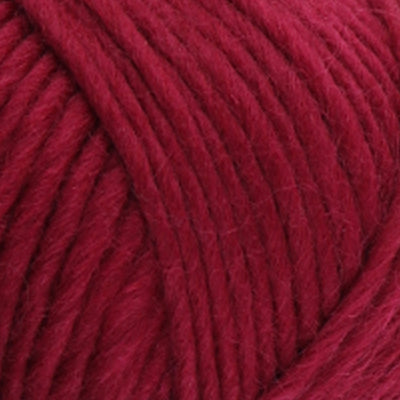 a close up of british bluefaced kerry hill fleece in burgundy chunky weight yarn for knitting weaving or crochet