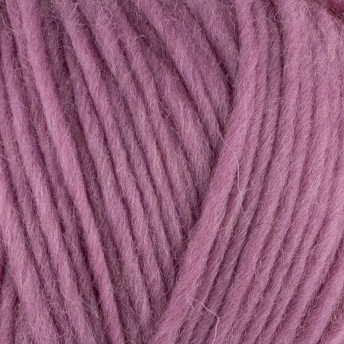 a close up of british bluefaced kerry hill fleece in light pink chunky weight yarn for knitting weaving or crochet