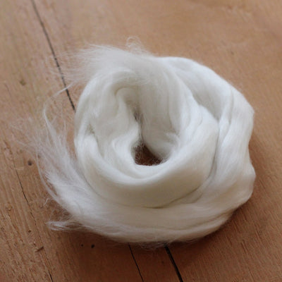white undyed bamboo vegan spinning fibre on a wooden floor 