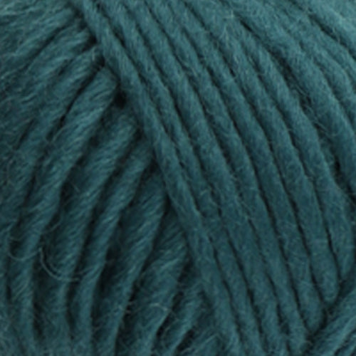 a close up of british bluefaced kerry hill fleece in teal chunky weight yarn for knitting weaving or crochet
