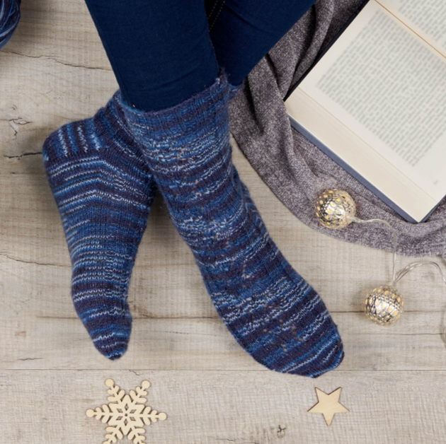 women wearing blue knitted socks book open christmas baubles blue leggings