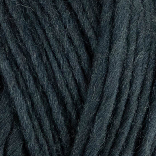 a close up of british bluefaced kerry hill fleece in dark grey chunky weight yarn for knitting weaving or crochet