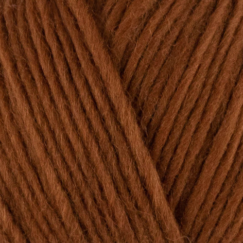a close up of british bluefaced kerry hill fleece in orange brown chunky weight yarn for knitting weaving or crochet