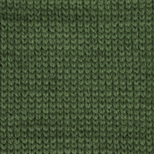 a close up of a knitted swatch green aran weight skein machine washable for knitting crocheting and weaving