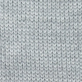 close up of knitted white aran weight skein machine washable for knitting crocheting and weaving