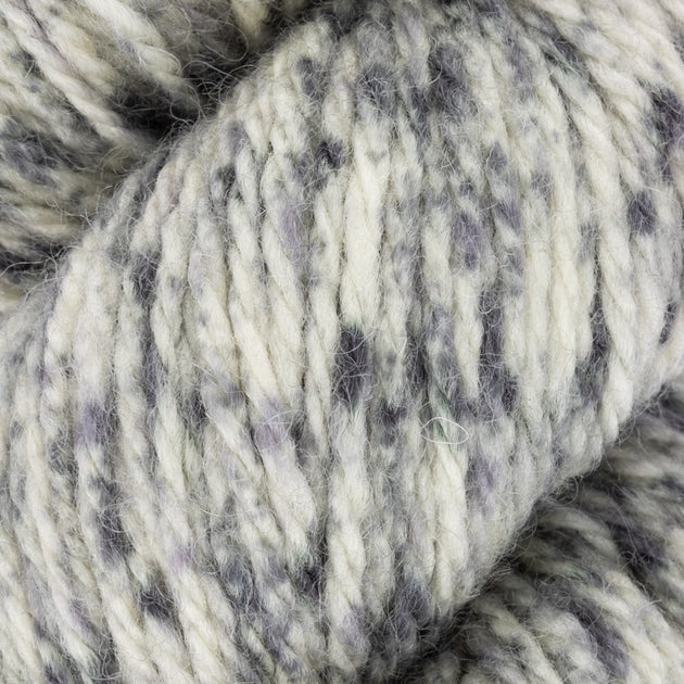 close up of white black grey  aran weight skein machine washable for knitting crocheting and weaving