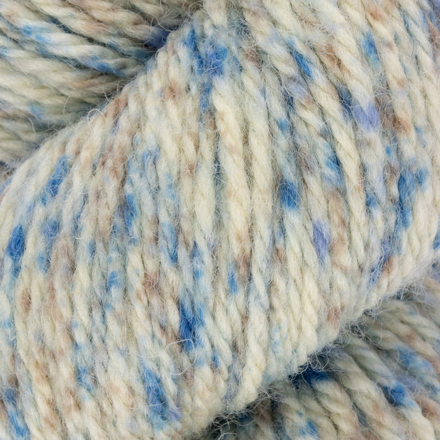close up of blue white cream  aran weight skein machine washable for knitting crocheting and weaving