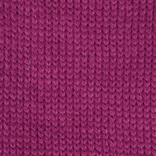 close up of knitted purple pink aran weight skein machine washable for knitting crocheting and weaving