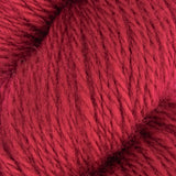 a close up of red aran weight skein machine washable for knitting crocheting and weaving