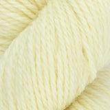 close up of knitted white cream aran weight skein machine washable for knitting crocheting and weaving