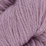 close up of knitted lilac purple pink aran weight skein machine washable for knitting crocheting and weaving