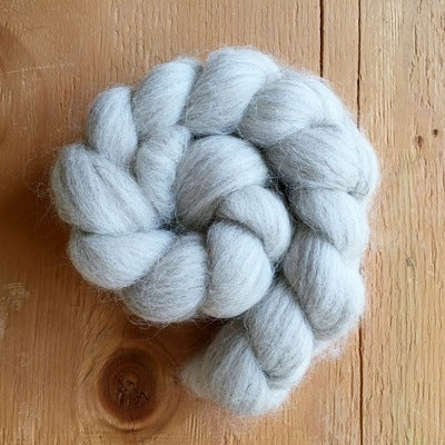 a braid of swaledale light grey 100% british wool on a wooden background